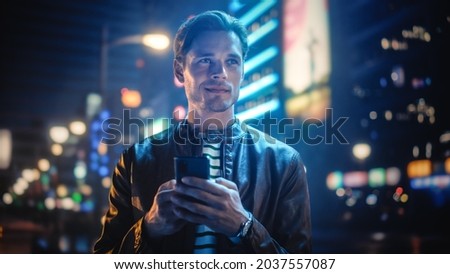 Urban style evening with a person using smartphone