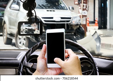 Man using a smart-phone while driving and getting a car crash on the road. CCTV car camera. Technology concept.