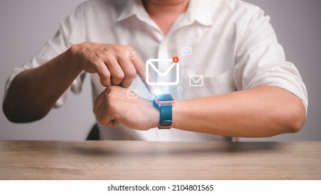 Man Using Smartwatch With E-mail Notifier. Smartwatch Hand Device Notify Computer Internet Message E-mail Concept