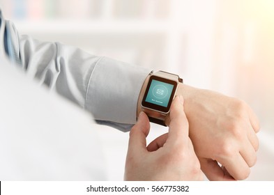 Man Using Smartwatch With E-mail Notifier. Smartwatch Hand Device Notify Computer Internet Message E-mail Concept