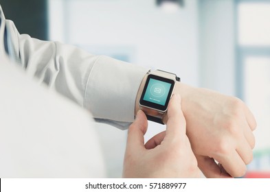 Man Using Smartwatch With E-mail Notifier. Smartwatch Hand Device Notify Computer Internet Message E-mail Concept