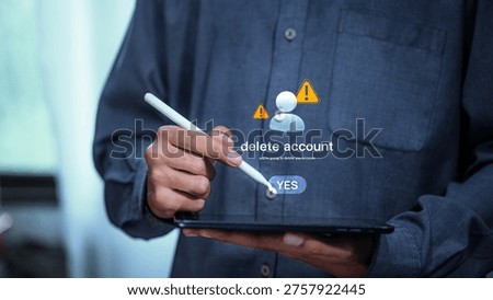 Man using stylus on tablet to confirm account deletion with warning icons, representing privacy control, data protection, cybersecurity risk, user decision, and digital identity management.
