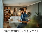 Man using tablet computer at home, browsing internet or working