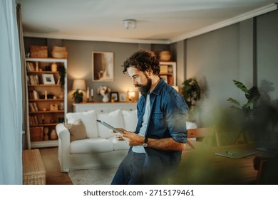 Man using tablet computer at home, browsing internet or working