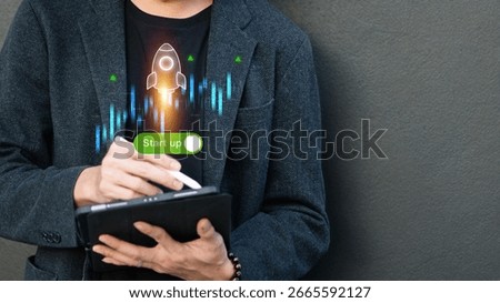 Man using tablet to launch startup with rocket icon and tech chart, concept of innovation, entrepreneurship, and digital growth.