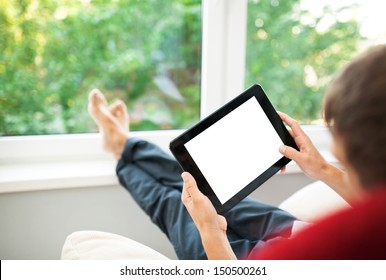 Man Using Tablet On Sofa At Home