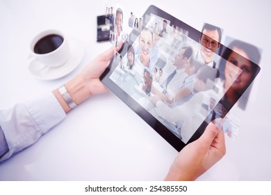 Man using tablet pc against group of business people brainstorming together