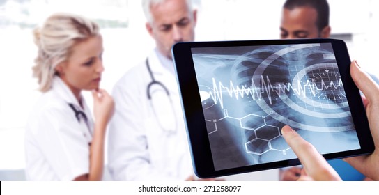 Man using tablet pc against three doctors using a tablet
