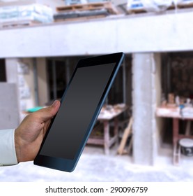 Man using tablet pc against workshop
