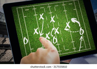 Man using tablet pc against rugby tactics