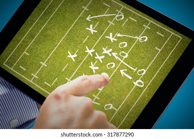 Man using tablet pc against rugby tactics