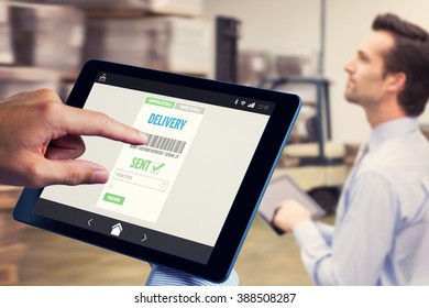 Man using tablet pc against manager using digital tablet in warehouse