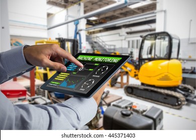 Man Using Tablet Pc Against Industrial Equipments In Factory