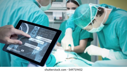 Man using tablet pc against medical interface on xray - Powered by Shutterstock