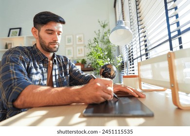 Man using a tablet pensively in a serene office space, bathed in sunlight filtering through venetian blinds, embodying a calm workday. - Powered by Shutterstock