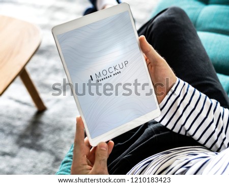 Man using a tablet with a screen mockup