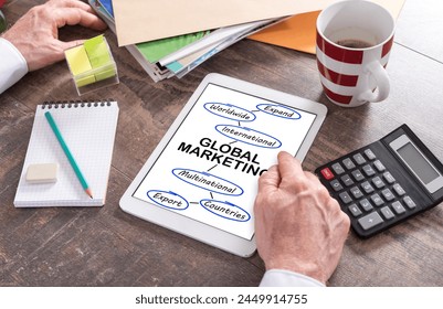 Man using a tablet showing a global marketing concept