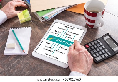 Man using a tablet showing a start up concept