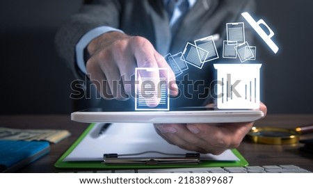 Man using tablet. Trash can and files. Delete files