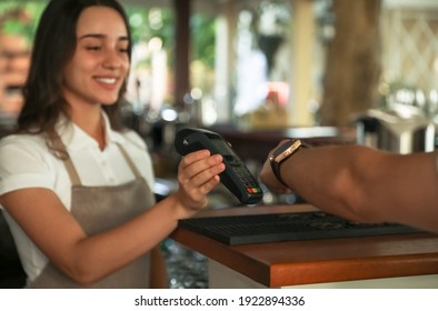 Man using terminal for contactless payment with smart watch in cafe, closeup - Powered by Shutterstock