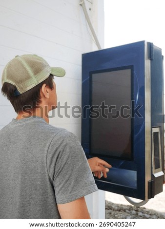 Man using touchscreen interface outdoor machine