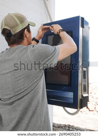 Man using touchscreen interface outdoor machine