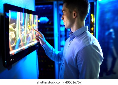 Man using touchscreen in university or museum