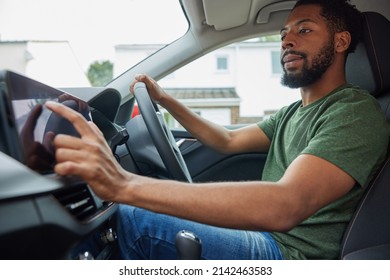 Man Using Touchscreen Whilst Driving Car - Shutterstock ID 2142463583