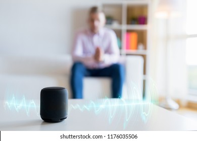 Man Using Virtual Assistant, Smart Speaker At Home