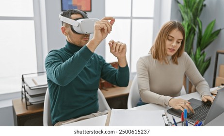 A man using virtual reality headset and woman working on laptop in a modern office setting.