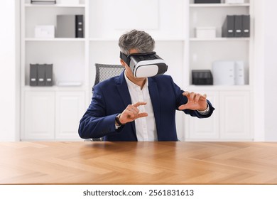 Man using virtual reality headset at desk in office