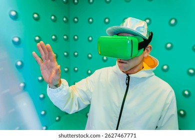 Man using virtual reality headset with raised arm standing over turquoise pattern background. Concept of modern innovation technology.