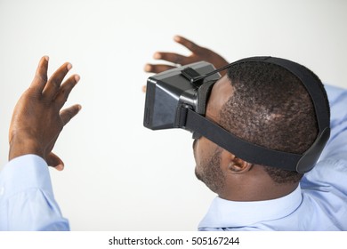 Man using virtual reality headset against white background