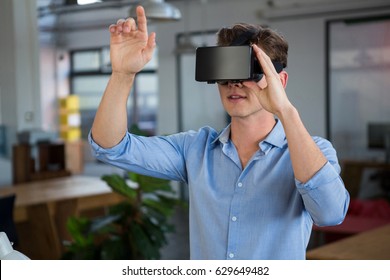 Man using virtual reality headset in creative office