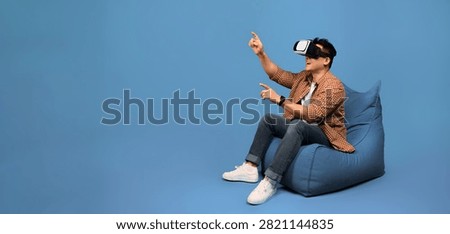 Man Using Virtual Reality Headset, Engaging In Immersive Experience, Focused At Home