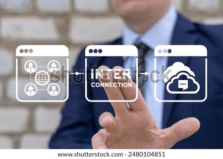 Man using virtual screen clicks text: INTERCONNECTION. Interconnected digital cyber era technology. Social networking interconnection communication concept. Big data and city interconnection tech.