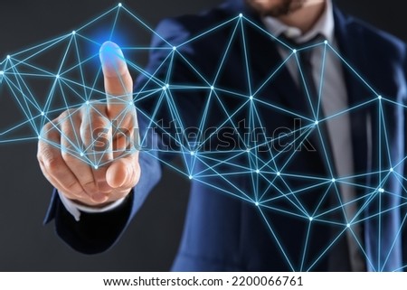 Man using virtual screen with connection lines presenting innovation network linkage on dark background
