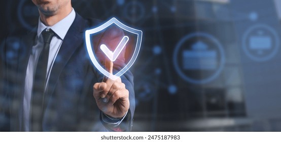Man using virtual screen with quality mark on dark background