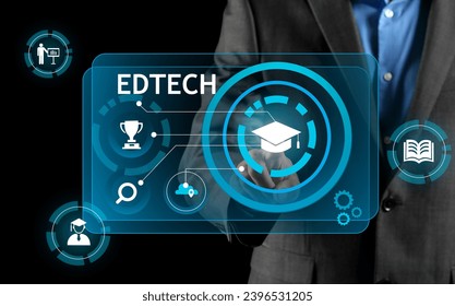 Man using virtual screen with text EDTECH on dark background