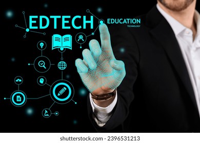 Man using virtual screen with text EDTECH on dark background