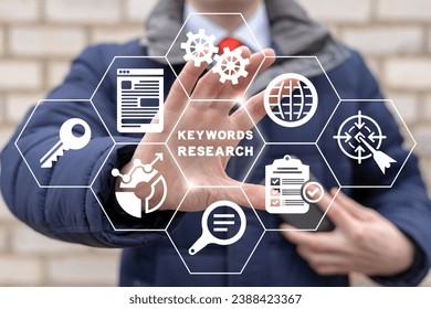 Man using virtual touch screen sees inscription: KEYWORDS RESEARCH. Keyword Research and SEO optimization concept. Selection popular search terms with search engine suggestion tips. Keywords planner.