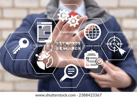 Man using virtual touch screen sees inscription: KEYWORDS RESEARCH. Keyword Research and SEO optimization concept. Selection popular search terms with search engine suggestion tips. Keywords planner.