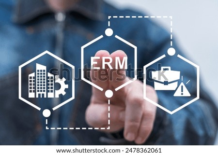 Man using virtual touch screen presses abbreviation: ERM. Enterprise Risk Management ( ERM ) Forecasting Evaluation Financial Business concept.