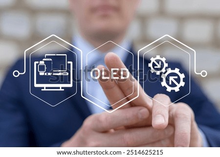 Man using virtual touch screen presses text: OLED. OLED ( Organic Light-Emitting Diode ) display information technology on TV, mobile devices, smartphones, computer monitor, laptop, smart watch.