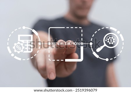 Man using virtual touch screen presses word: REVALUATION. Revaluation Business Finance concept. Revalue and calculate. Business failure and crisis.