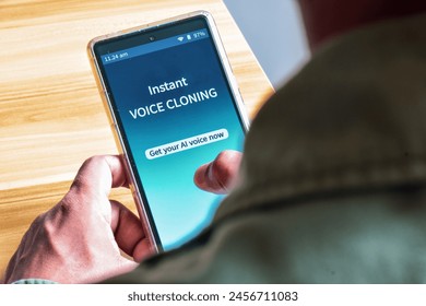 Man using Voice Cloning mobile applications to create AI voice. The danger and benefits of artificial intelligence use concepts.