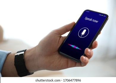 Man Using Voice Search On Smartphone Indoors, Closeup