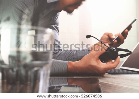 Man using VOIP headset with digital tablet computer docking smart keyboard, concept communication, it support, call center and customer service help desk,filter effect 
