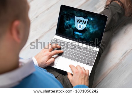 Man using VPN (Virtual Private Network) for secure and encrypted connection, also using internet anonymously.