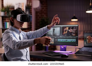Man using vr glasses to edit film footage with computer software app. Videographer editing movie montage with visual and sound effects, creating video for multimedia production. - Shutterstock ID 2215319665